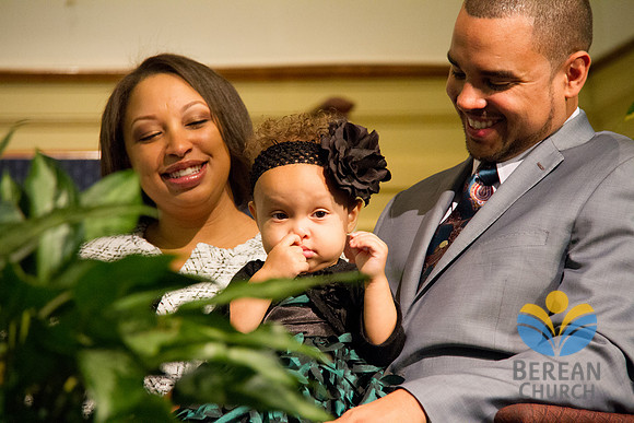 The Bostons affectionately look at their daughter, Riley.  (Official Berean SDA Church Photo by Burdie Henri)