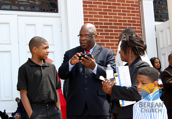 Pastor Russell visiting with members at reception