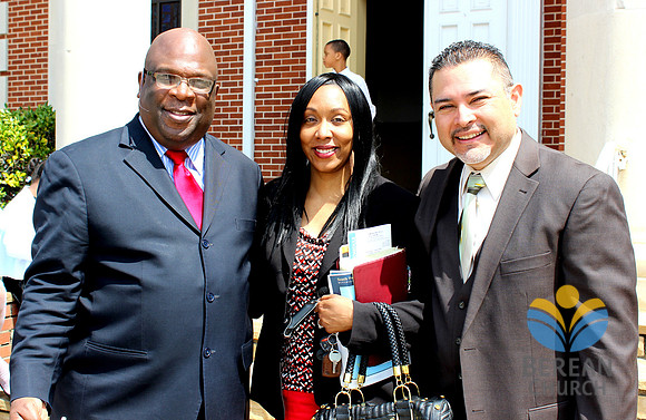 Pastor Russell visiting with members at reception