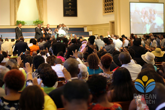 Stretched hands in support of baby blessings