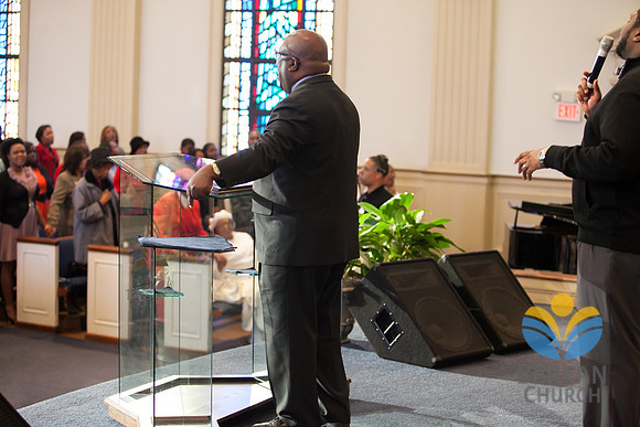 Pastor Russell addresses the congregation