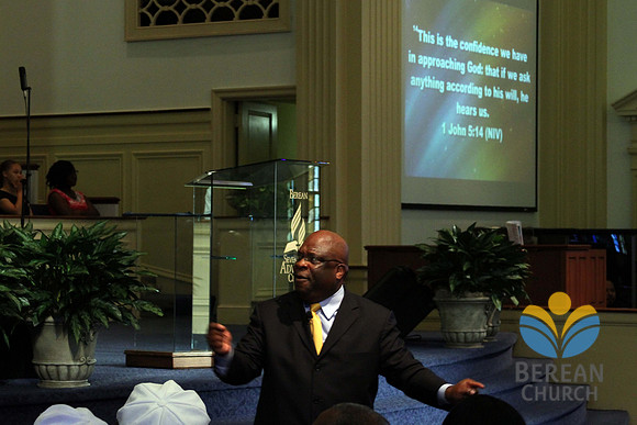 Pastor Russell reads "...ask anything according to His will, He hears us." 1 John 5:14 (NIV) from the screen. . April 28, 2012 (Official Berean SDA Church Photo by David Stewart)