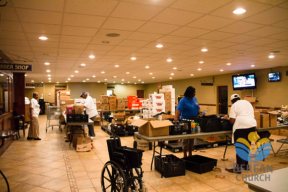 Volunteers package food in bags for distribution to the community