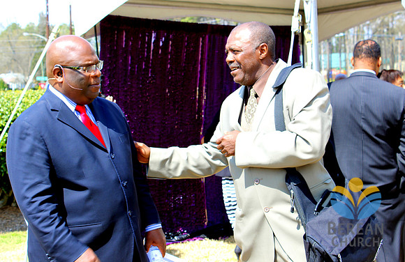 Pastor Russell visiting with members at reception