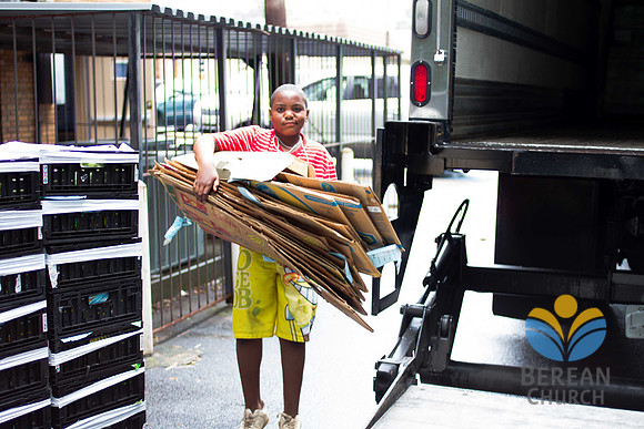 A young volunteer discards boxes.